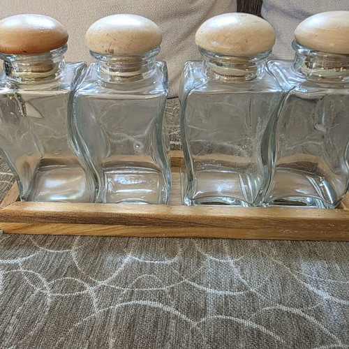 Set of 4 glass jars with wooden lids and wooden base like new