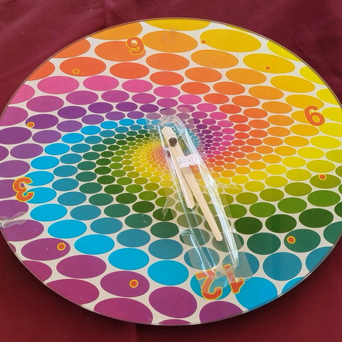 Glass pop art wall clock with spiral design and vibrant colors
