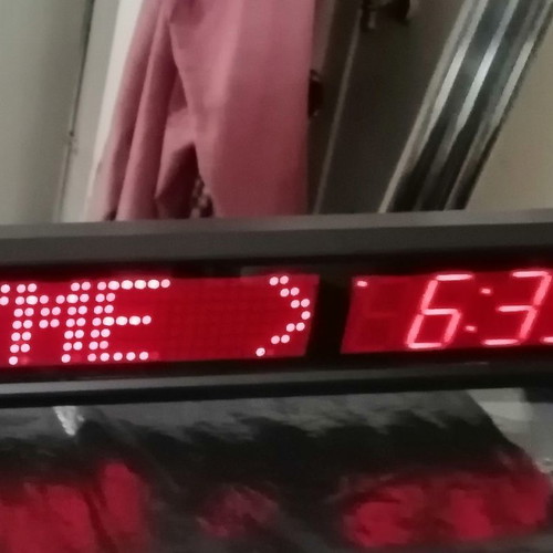Electronic sign with running letters and clock used, 106x11 cm