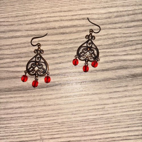 Earrings used with red plastic beads and bronze metal