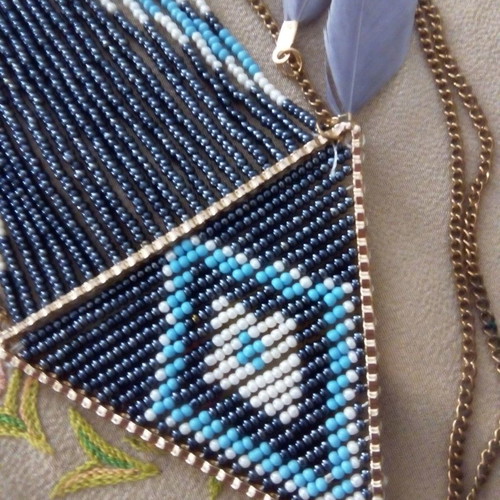 Ethnic necklace used with beads and feathers