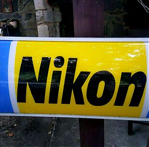 Φωτεινή πινακίδα Nikon σε καλή κατάσταση.