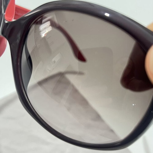 Christian Dior sunglasses used, black and red frame, lens scratched