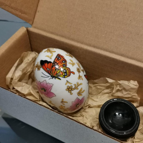 Porcelain egg used with butterflies and wooden base
