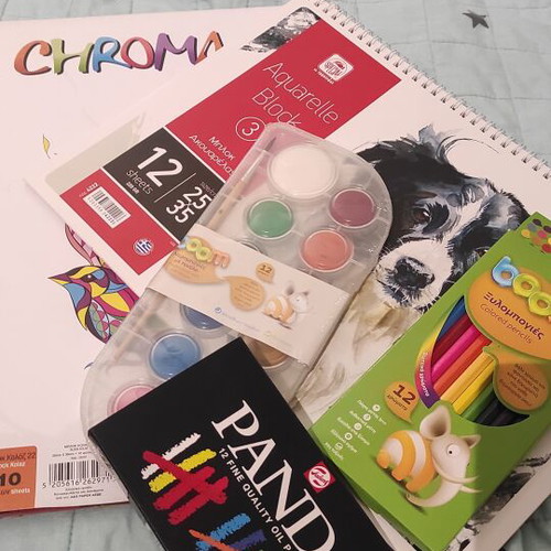 Art supplies set like new with oil pastels, watercolors, colored pencils, and watercolor block