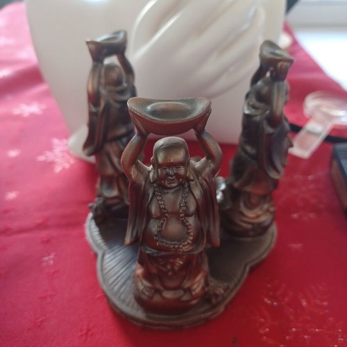 Asian candlestick with 3 smiling figures used, bronze finish