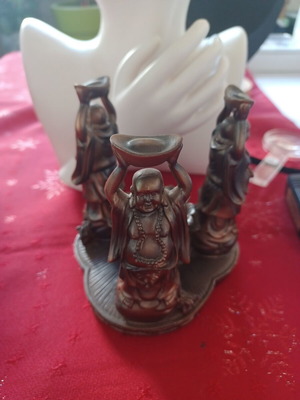 Asian candlestick with 3 smiling figures used, bronze finish