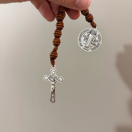 Religious bracelet with wooden beads, cross pendant, and Saint Benedict medal