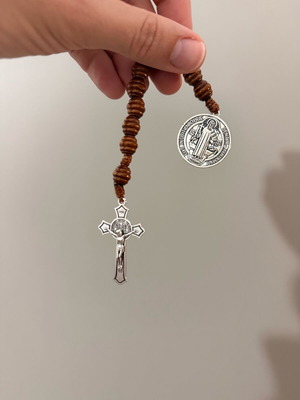 Religious bracelet with wooden beads, cross pendant, and Saint Benedict medal