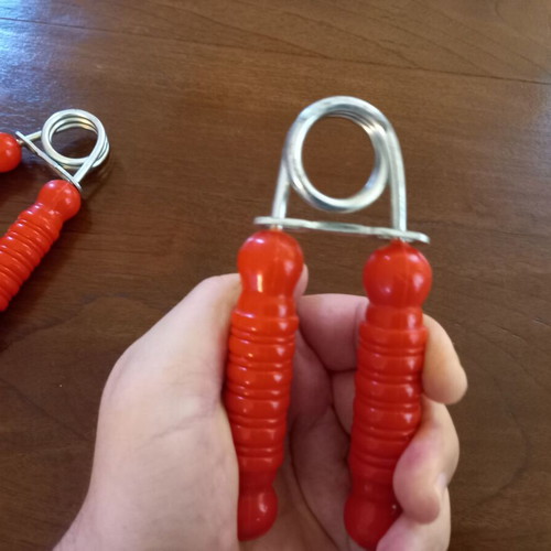 Set of 2 hand grip strengtheners used, red