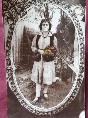 Vintage photo of girl with flowers in oval decorative frame used