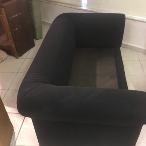 Two-seater black sofa used with wooden legs and washable fabric