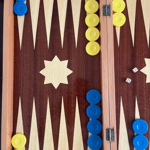 Wooden backgammon set used with colorful checkers and dice