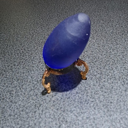 Vintage decorative crystal egg with blue matte glass and gold metal base used