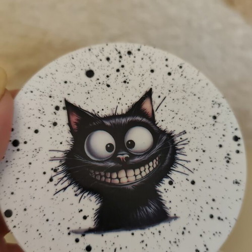 Handmade coasters with black base and 4 playful cat designs