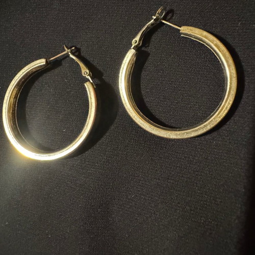 Thick silver hoop earrings used with some imperfections