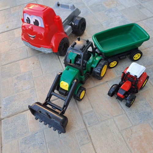 Set of 3 children's plastic vehicles: green tractor with loader and trailer, red truck, small red and black tractor