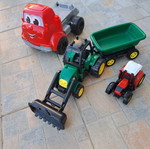 Set of 3 children's plastic vehicles: green tractor with loader and trailer, red truck, small red and black tractor