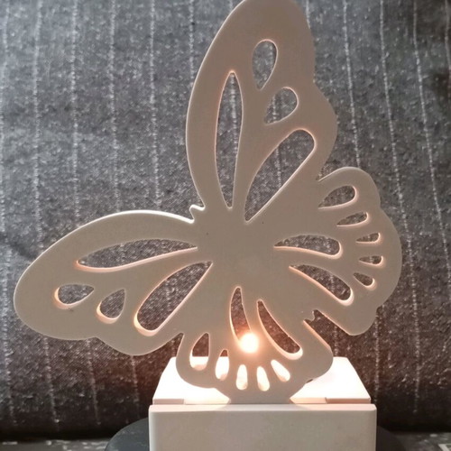 Decorative candle holder with butterfly design in white porcelain powder