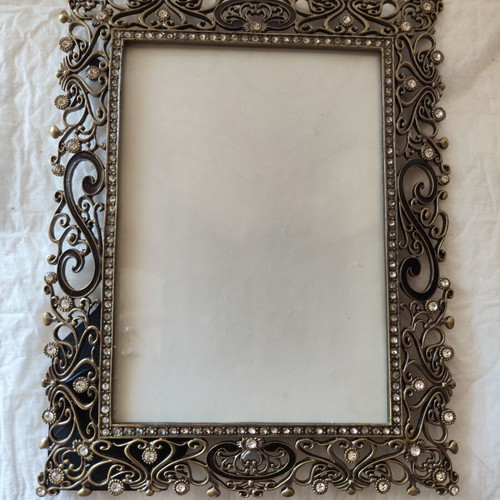 Decorative metal antique frame with baroque floral reliefs