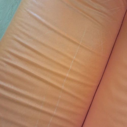 Orange two-seater sofa leather used with minor damages