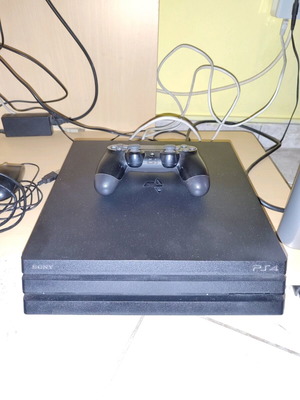 PS4 Pro console used with controller, game and cooling fan