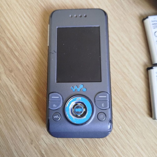 Sony Ericsson w580i used for parts with charger, headphones, and batteries