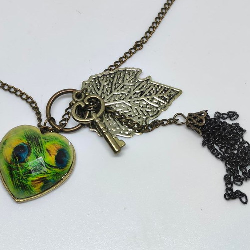 Vintage necklace with antique bronze elements and peacock feather heart pendant like new