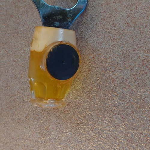 Decorative bottle opener used with wear around the magnet