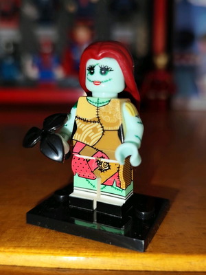 Sally Lepin figure like new with base and black flower