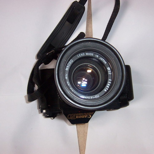 Canon T50 SLR analog camera used with two zoom lenses and flash