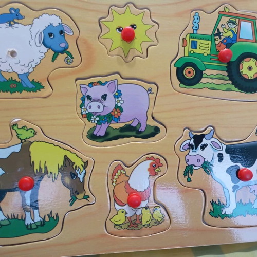 Wooden puzzle used with farm theme, missing one peg