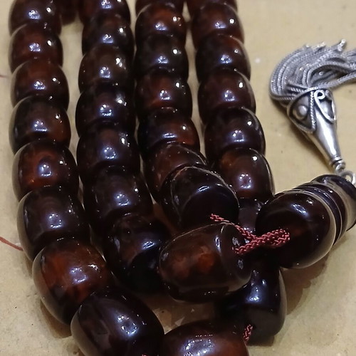Amber worry beads used with silver elements and tassel