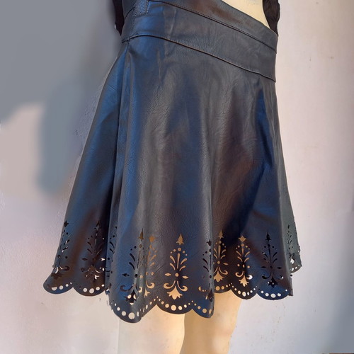 Laser cut skirt made of black faux leather used with handmade details