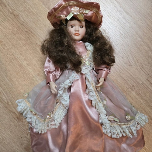 Glass doll like new with satin rotten apple dress and hat