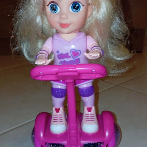 Doll on electric scooter with songs and lights, like new