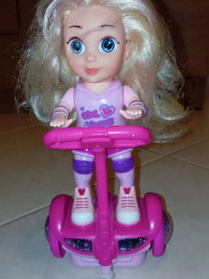 Doll on electric scooter with songs and lights, like new