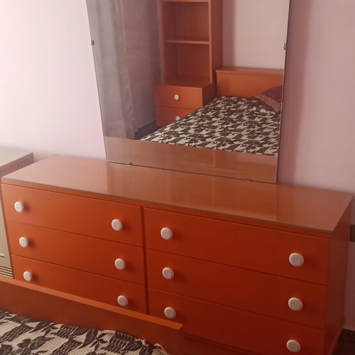 Wooden bedroom set with bed, mattress, nightstands, bookshelf, dresser with mirror