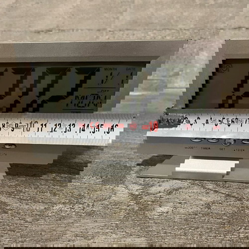 Digital table clock used with alarm and thermometer