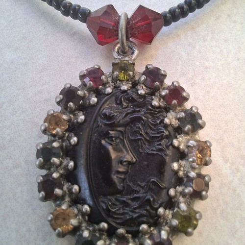 Necklace black with colorful stones and embossed face vintage like new
