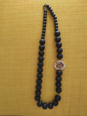 Necklace new with black stones and brown wood texture