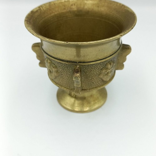 Metal mortar used with face and plant decoration