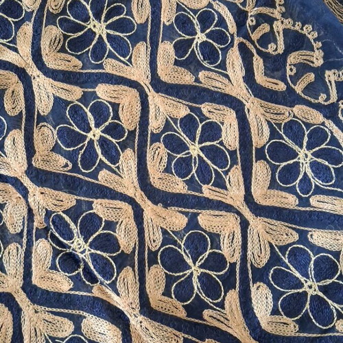 Blue embroidered decorative square used with gold thread