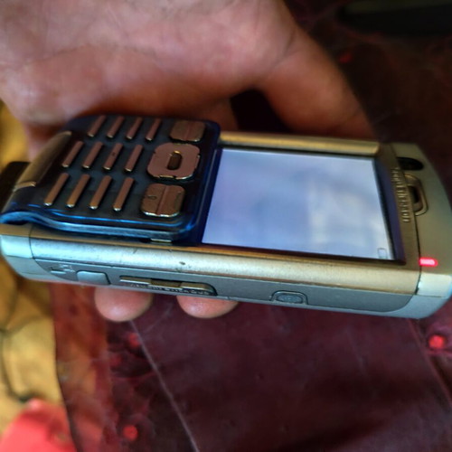 Sony Ericsson P990i vintage cell phone used with charger