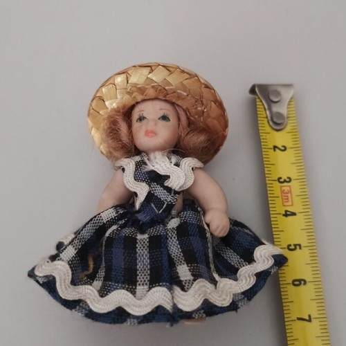 Collectible porcelain doll like new with straw hat and blue checkered dress