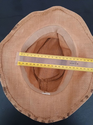 Straw-like hat used, tan with marks