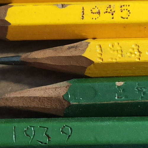 Wooden stationery box with used pencils and ink cartridges set