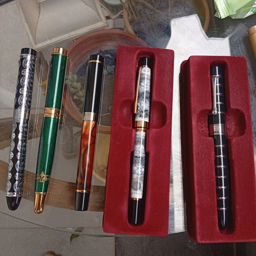Pens in like-new condition with various designs
