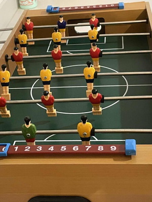 Children's foosball table used without balls and missing one handle