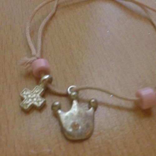 Pink bracelet with beads, cross and crown, used